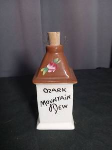 lot 6921 image: Ozark Mountain Dew Bottle Shaped Ceramic Decanter with Cork Stopper