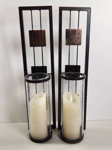 lot 179 image: Set of 2 Black Metal Candle Holders with Glass Cylinders and Decorative Accents