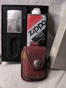 lot 2504 image: Zippo Windproof Lighter with Leather Pouch and Fluid  Leather Case Zippo&nbsp