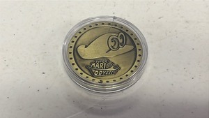lot 46 image: Super Mario Odyssey Commemorative Medal in plastic capsule