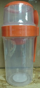 lot 65 image: Plastic Container Cup with Lid and Spoon Orange