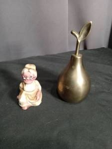 lot 7097 image: Gold-Tone Pear-Shaped Bell and Seated Elderly Woman Figurine 2-Piece Lot