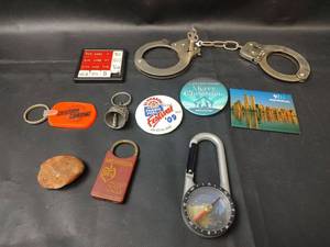 lot 395 image: Keychains, Pins, Handcuffs, Compass and More