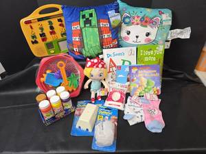 lot 650 image: Kids Toys - Pillow, Books, Doll, Outlet Covers, Bubbles, and Beach Toys