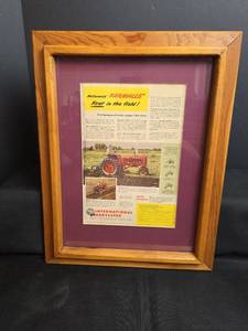lot 215 image: McCormick Farmalls First in the Field Framed Advertisement