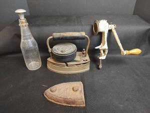 lot 312 image: Antique Fuel Iron, Sad Iron, Meat Grinder and Glass Bottle with Aluminum Sprinkler