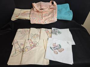 lot 651 image: Hand-Embroidered Dish Towels with Lighthouse and Kitchen Designs, Apron, and Laundry Bag