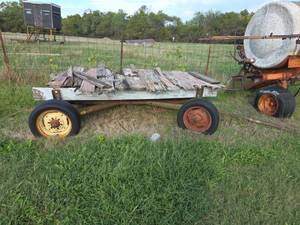lot 2021 image: Farm Wagon Trailer with Wood Bed and Metal Frame- Needs Repairs- see description for removal information.