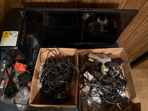 lot 111 image: Electronics - Cyber Power UPS, 24 LG TV, and Cords from Around the House