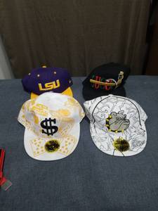 lot 1295 image: Lot of 4 Snapback Caps LSU and Graphic Designs
