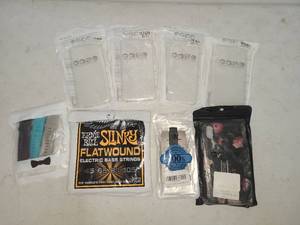 lot 108 image: Case Mobile Phone Cases 4-Pack & Ernie Ball Slinky Electric Bass Strings Bundle