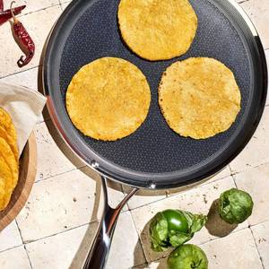 lot 1566 image: $139 HexClad 12 Hybrid Nonstick Griddle Pan, BBQ, Dishwasher and Oven Safe  Stay-Cool Handles, Dishwasher and Oven Safe up to 900 F, Compatible with All Cooktops 12-inch