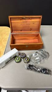 lot 121 image: Lane Wooden Jewelry Box, 3 small round tins with floral patterns, small propane tank trailer, and military themed stretchy bracelets and a strap
