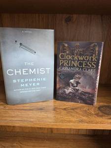 lot 714 image: The Chemist by Stephenie Meyer & Clockwork Princess by Cassandra Clare 2-Book Lot  (books may or may not have an Ex Libris this Book Belongs To sticker on first page)