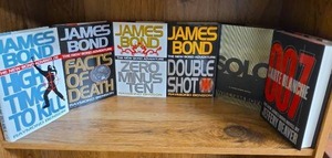 lot 718 image: James Bond Novel Collection 6 Books by Raymond Benson, William Boyd, and Jeffery Deaver  - all first editions except Solo by Boyd  (books may or may not have an Ex Libris this Book Belongs To sticker on first page)