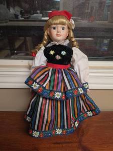 lot 740 image: Porcelain Doll with Blonde Braids Red Hat Striped Dress Embroidered Details