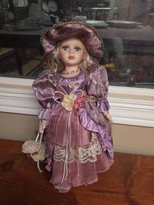 lot 741 image: Emerald Doll Collection Porcelain Doll Purple Dress with Hat