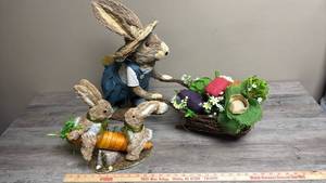 lot 501 image: Decorative Rabbit Decor Figures made from natural Sisal one has a wheelbarrow, the others are on a carrot see-saw
