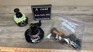lot 516 image: A Real Witch Lives Here With Her Little Monsters Soap Dispenser, Witches Hat Votive Holder and a Bag of Spider Rings.