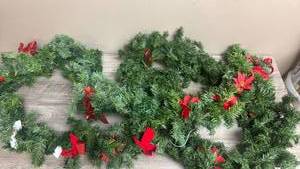 lot 556 image: Evergreen Garland with Red Poinsettia Flowers and Ribbon Bows
