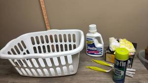 lot 584 image: Laundry Basket White Plastic with Woolite Detergent,  Sta-Flo Starch, and Swiffer Dusters