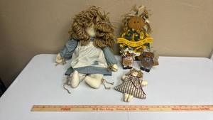 lot 644 image: 2 Handmade Fabric Dolls and a Wooden Doll Figure wearing a Sunflower dress that says Kansas Winds Make Me Ugly