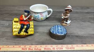 lot 656 image: Vintage Ceramic Baby Themed Soup Mug, Metal Trinket Box with Blue and White Porcelain Lid, Child Ceramic Figurine, and a Ceramic Fiddler on the Roof Music Box