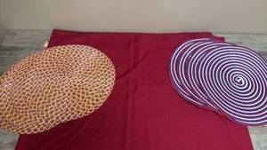 lot 665 image: Tablecloth and 2 sets of 4 placemats.Purple, Maroon and Yellow Diamond Pattern and Red, White, and Blue Circular Pattern.