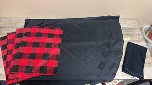 lot 666 image: Set of 4 Red and Black Buffalo Check Placemats and Solid Black Round Tablecloth.