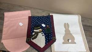lot 668 image: Three Table Runners, 12.5 x 35 Snowman, 14 x 72 Bunny and 12 x 72 Solid Pink.