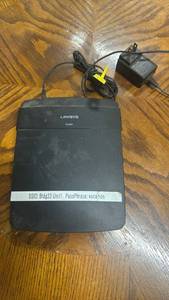 lot 308 image: Linksys E1200 Wireless Router with Power Adapter