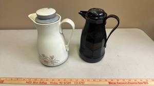 lot 445 image: 2 Coffee Pitchers with Lids White with Floral Motif and Black