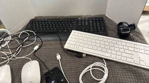 lot 1100 image: HP and Logitech keyboards and computers mouse along with Microsoft web cam