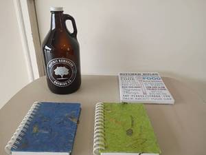 lot 2228 image: Glass Brewing Jug, 64oz.  Sign 9x7 and 2 Notebooks.   The covers are made with banana bark