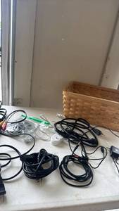 lot 2315 image: Various cords and chargers with storage basket