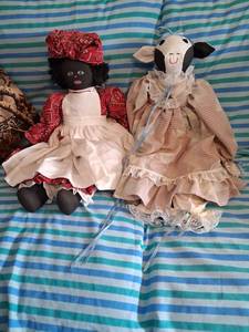 lot 56 image: 2 old cloth dolls. One is a girl  and the other is a cow.