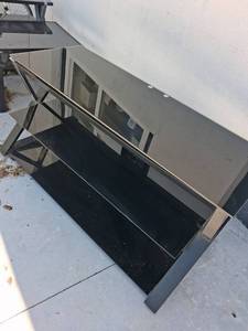 lot 73 image: Glass Top TV Stand with X-Frame Base and Storage Shelves 27 inches