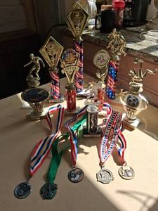 lot 93 image: Lot of 9 Sports Trophies with Medals and Ribbons
