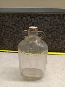 lot 190 image: Vintage Glass Bottle with Dual Handles and Metal Cap