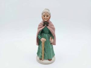 lot 290 image: Ceramic Figurine Old Woman w Cape & Walking Stick