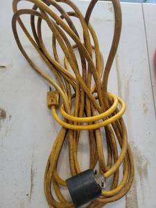 lot 15 image: Yellow Cloth Covered Extension Cord with Round Black Plug - Retail $0