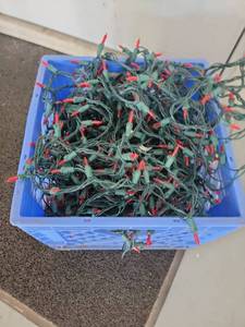 lot 140 image: String lights with red bulbs green wire cords in blue crate multiple sets - Retail $0