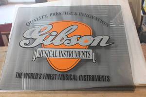 lot 3196 image: Gibson Musical Instruments Glass Store Sign 17 x21