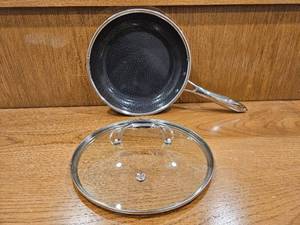 lot 252 image: $158 HexClad 10 Hybrid Nonstick Frying Pan with Lid, Dishwasher & Oven Safe  Stay-Cool Handles, Dishwasher and Oven Safe up to 900 F, Compatible with All Cooktops