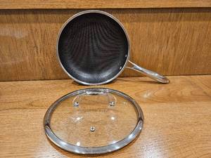 lot 254 image: $158 HexClad 10 Hybrid Nonstick Frying Pan with Lid, Dishwasher & Oven Safe  Stay-Cool Handles, Dishwasher and Oven Safe up to 900 F, Compatible with All Cooktops