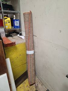 lot 7010 image: Woven Rug Roll with Rust Orange Border