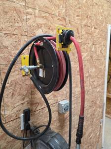 lot 7660 image: Wall-Mount Hose Reel with Red and Black Hoses
