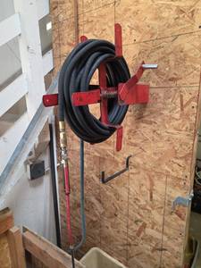 lot 7668 image: Red Metal Hose Reel with Black Rubber Hose