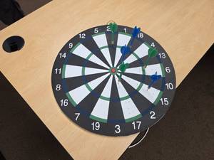 lot 7944 image: Dartboard with Numbered Segments and Three Darts