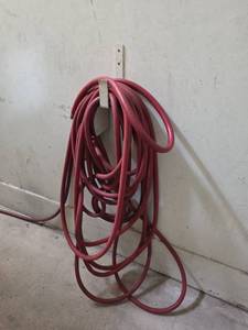 lot 7964 image: Red Garden Hose with Wall-Mount Bracket